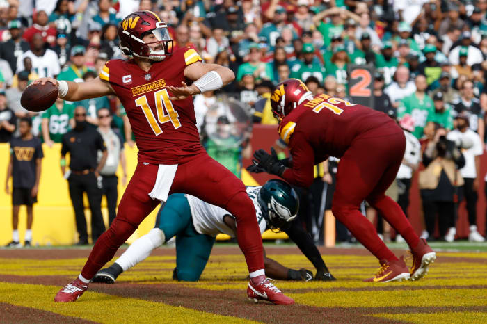 Washington Commanders quarterback Sam Howell (14) passes the ball from his end zone against the Philadelphia Eagles during the third quarter at FedExField.